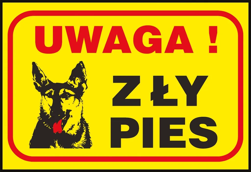 Żółta tabliczka z czerwoną ramką i napisem „UWAGA! ZŁY PIES” oraz grafiką czarnego psa.