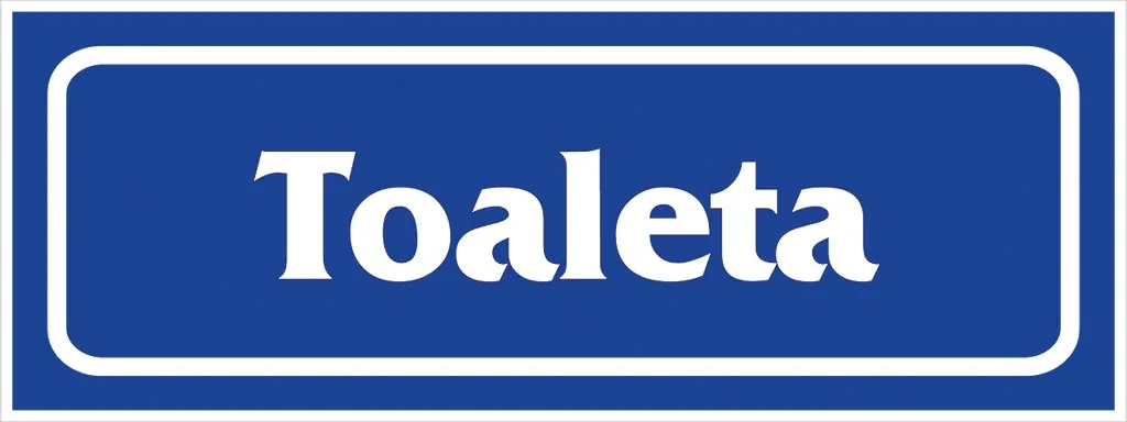 Prostokątny, niebieski znak z białym napisem „Toaleta”. Znak o zaokrąglonych rogach, przeznaczony do oznaczania lokalizacji toalet.