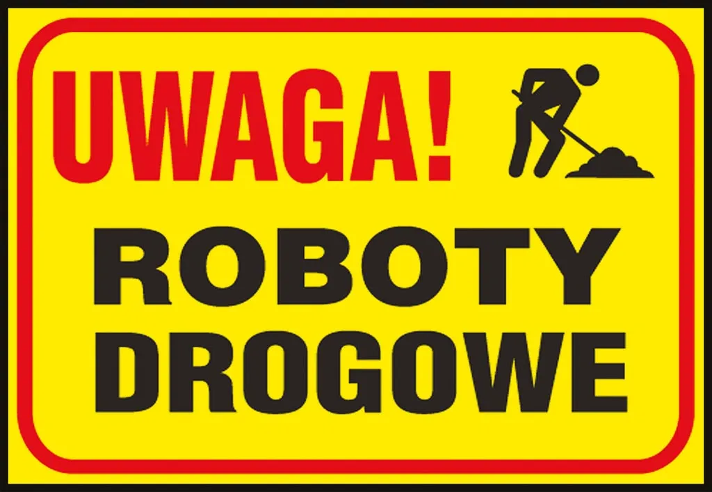 Tablica ostrzegawcza o żółtym tle z napisem „UWAGA! ROBOTY DROGOWE” oraz czarnym piktogramem przedstawiającym postać pracującą przy kopaniu.