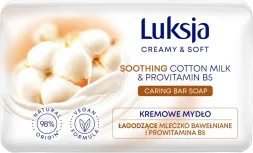 Opakowanie kremowego mydła w kostce Luksja o masie 90 g. Produkt zawiera łagodzące mleczko bawełniane i prowitaminę B5, jest wegański i ma 98% składników pochodzenia naturalnego.