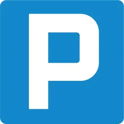 Znak parkingowy o prostokątnym kształcie, na niebieskim tle znajduje się biała litera 