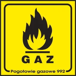 Znak bezpieczeństwa o żółtym tle z czarną grafiką płomienia i napisem „GAZ” w dolnej części. Pod spodem dodatkowy napis „Pogotowie gazowe 992”.