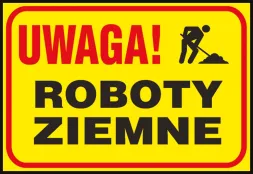 Tablica z żółtym tłem, na której znajduje się czarny napis „UWAGA! ROBOTY ZIEMNE” oraz ikona osoby pracującej z łopatą.